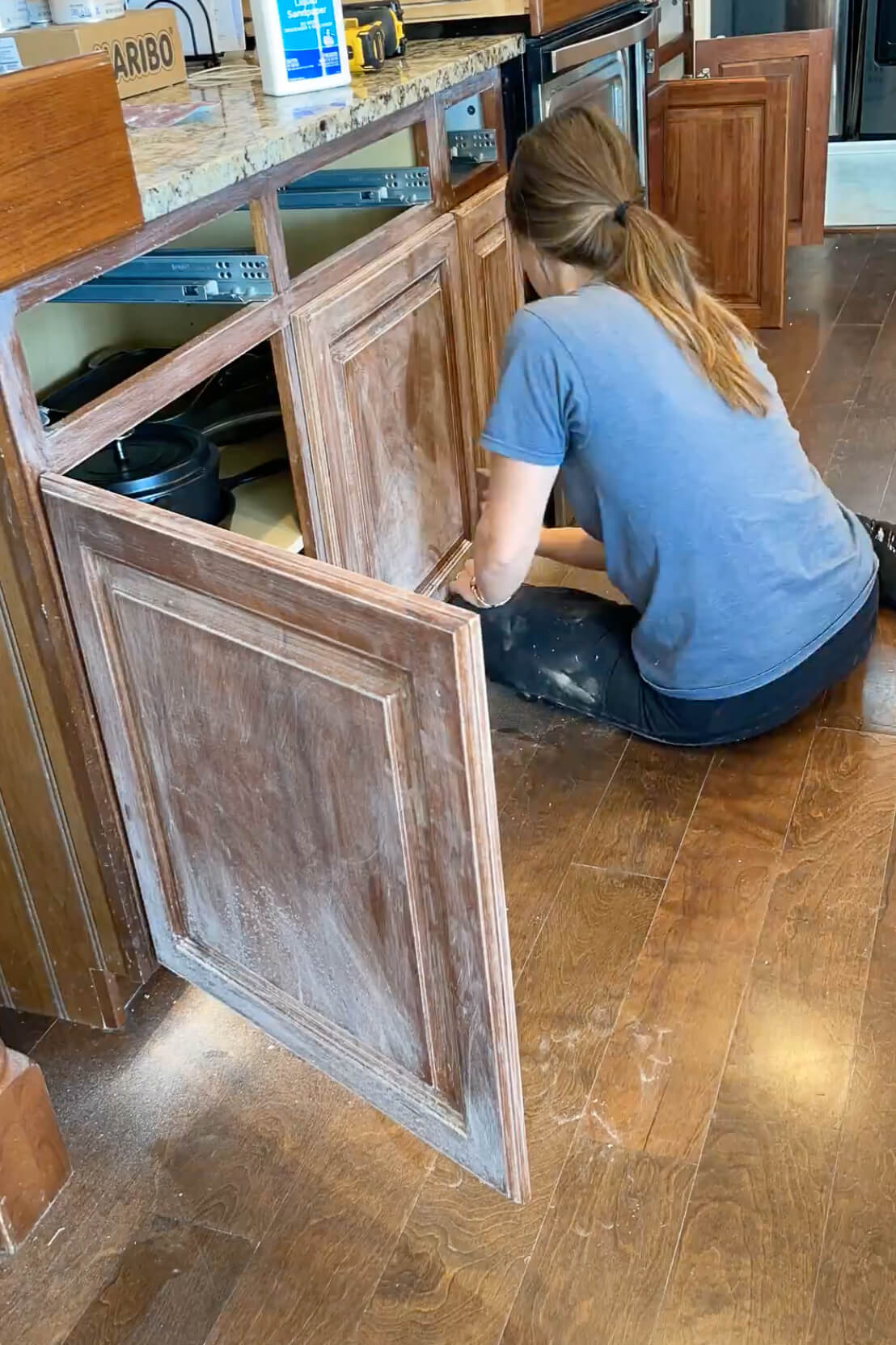 Sanding kitchen cabinet doors to get ready for cabinet paint.